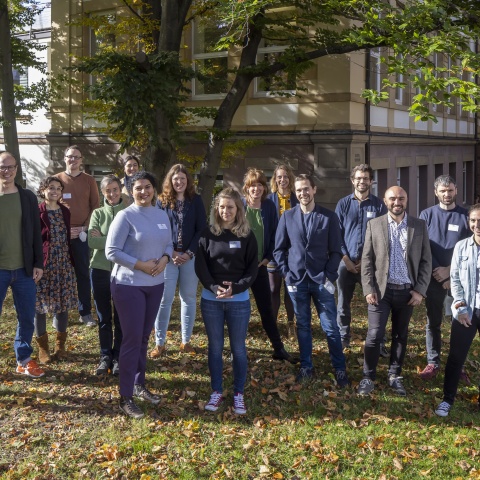 Young researchers in front of the university building.
