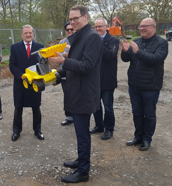 Mayor Wolf with a toy excavator